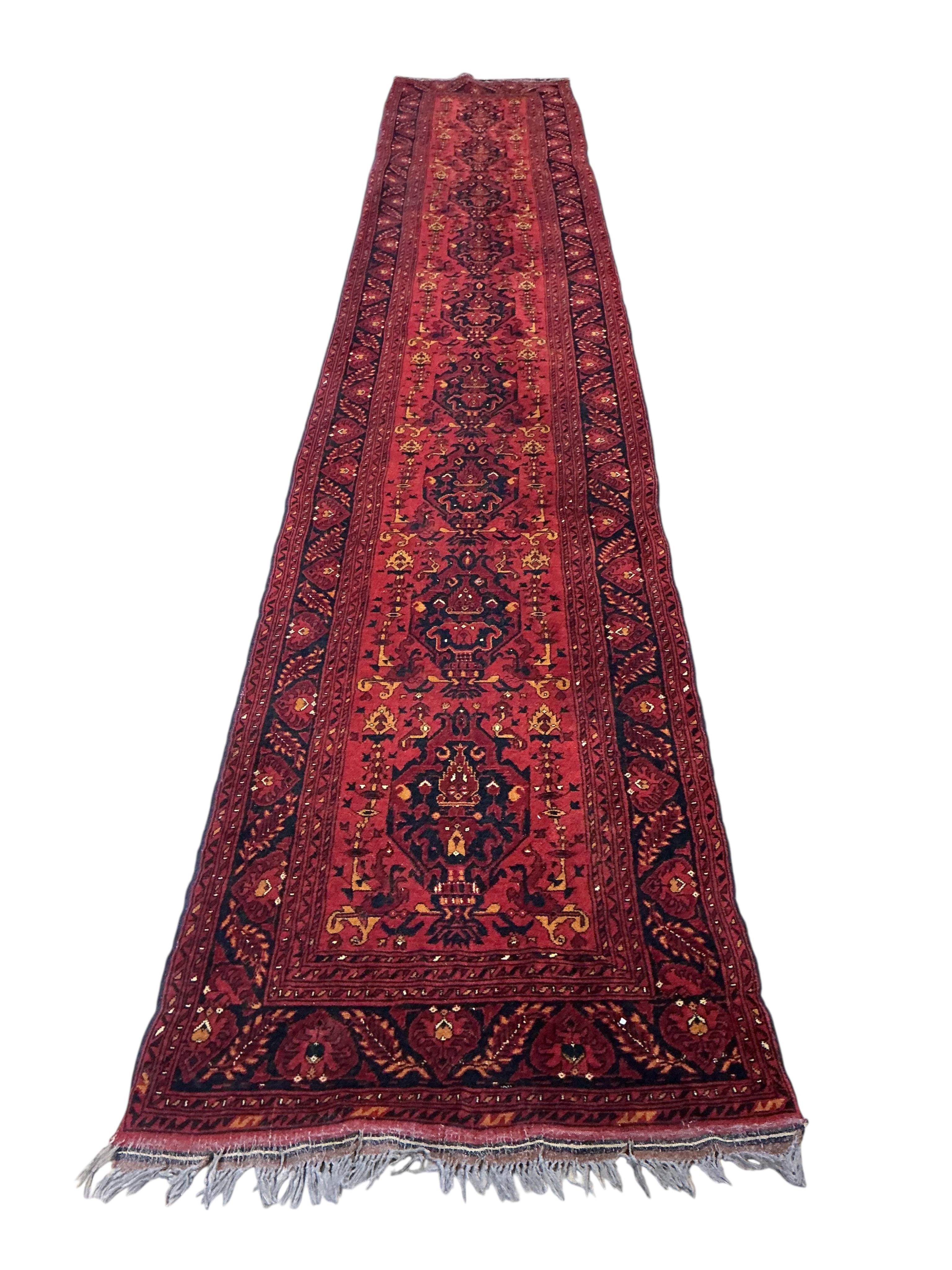 A 20th century red ground Persian runner, approx. 480 x 84cm